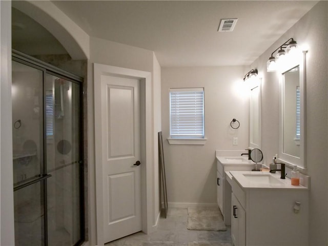 bathroom with vanity and a shower with shower door