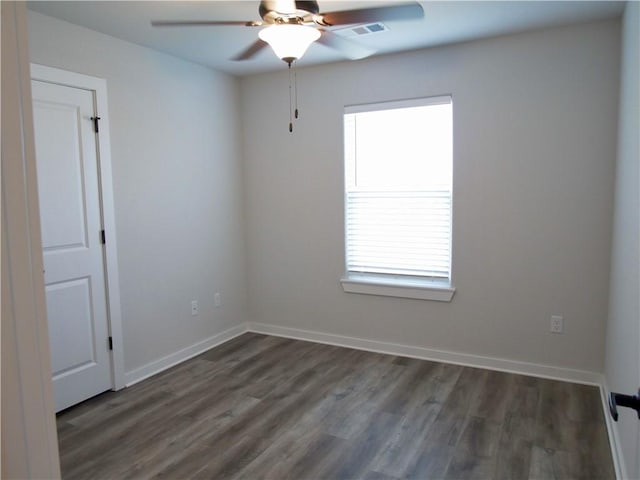 spare room with ceiling fan and dark hardwood / wood-style flooring