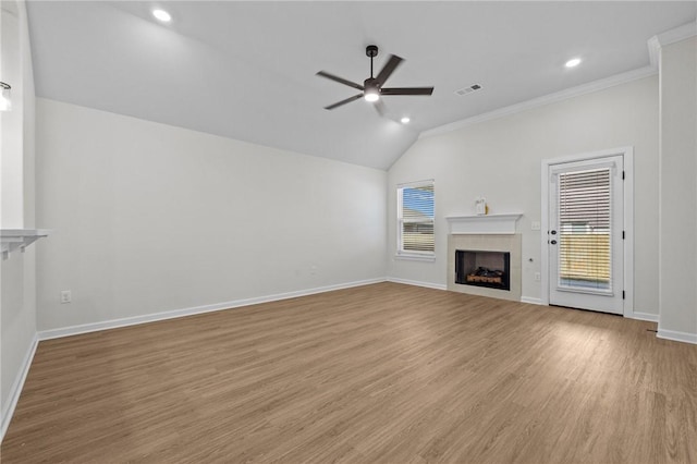 unfurnished living room featuring crown molding, ceiling fan, plenty of natural light, and vaulted ceiling