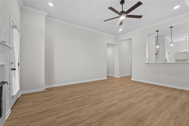 unfurnished living room with ceiling fan with notable chandelier, wood-type flooring, and ornamental molding