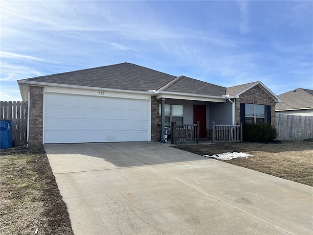 ranch-style home with a garage and covered porch