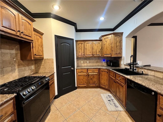 kitchen featuring tasteful backsplash, crown molding, sink, and black appliances