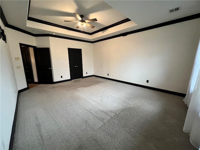 unfurnished bedroom featuring crown molding, a raised ceiling, and ceiling fan