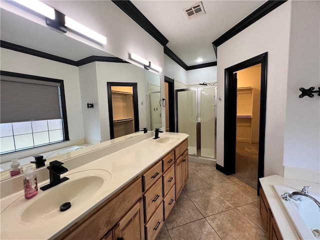 bathroom with crown molding, tile patterned floors, shower with separate bathtub, and vanity