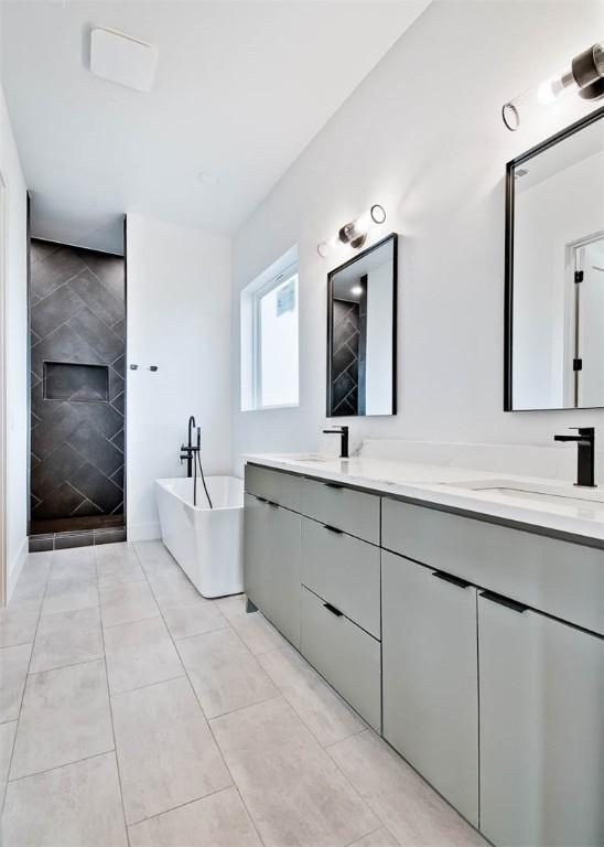 bathroom with tile patterned floors, vanity, shower with separate bathtub, and a fireplace