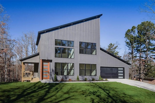 contemporary home featuring a garage and a front yard