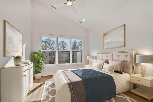 bedroom with lofted ceiling, ceiling fan, and light wood-type flooring