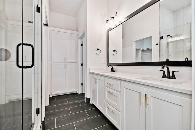 bathroom with tile patterned floors, vanity, and a shower with door