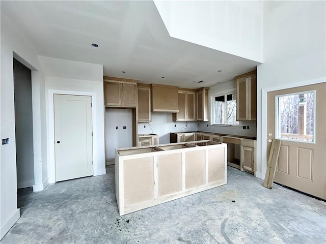 kitchen featuring light brown cabinetry, wall chimney exhaust hood, and a kitchen island