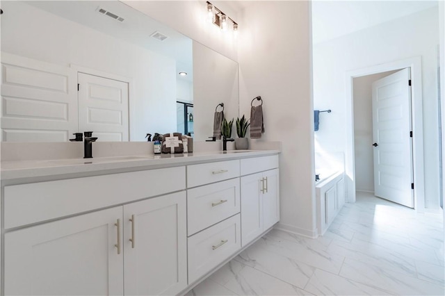 full bathroom with double vanity, visible vents, marble finish floor, and a sink