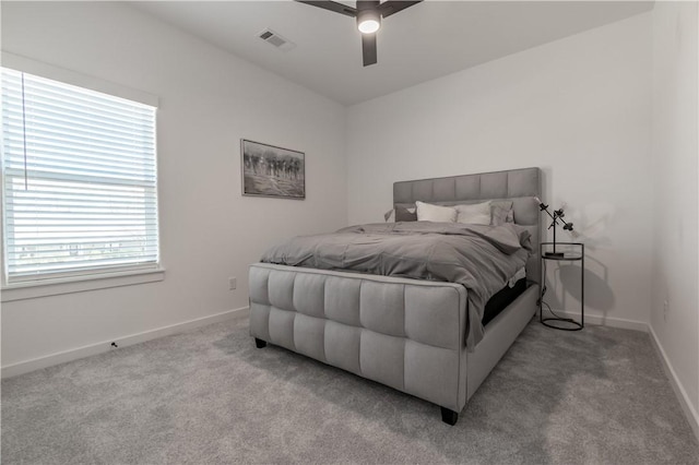 bedroom with light carpet, visible vents, a ceiling fan, and baseboards