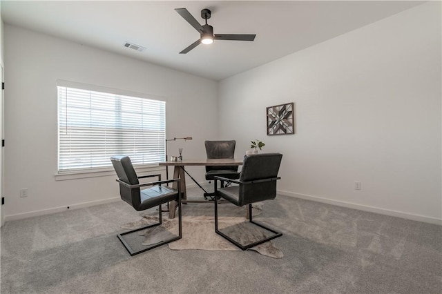 office space featuring visible vents, baseboards, carpet floors, and ceiling fan