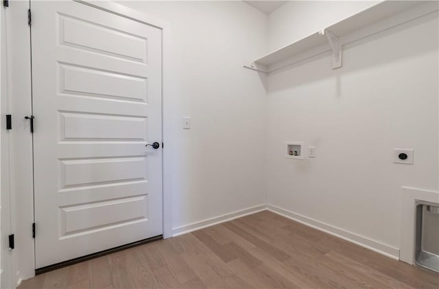 laundry room featuring baseboards, hookup for a washing machine, laundry area, and light wood finished floors