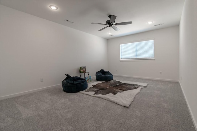 unfurnished room with carpet, visible vents, and baseboards