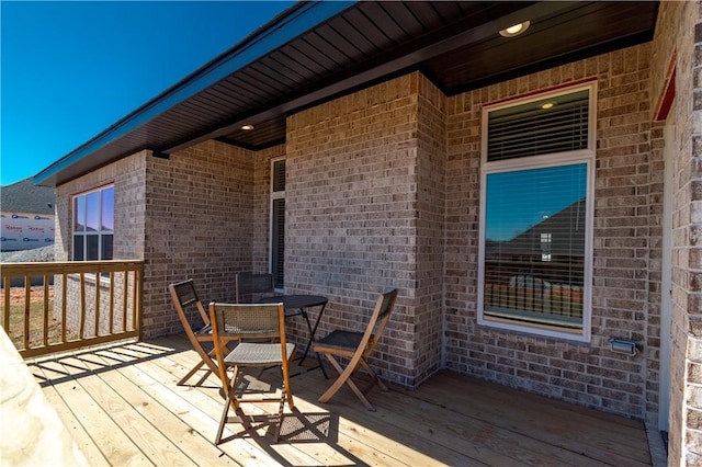 wooden terrace with outdoor dining area