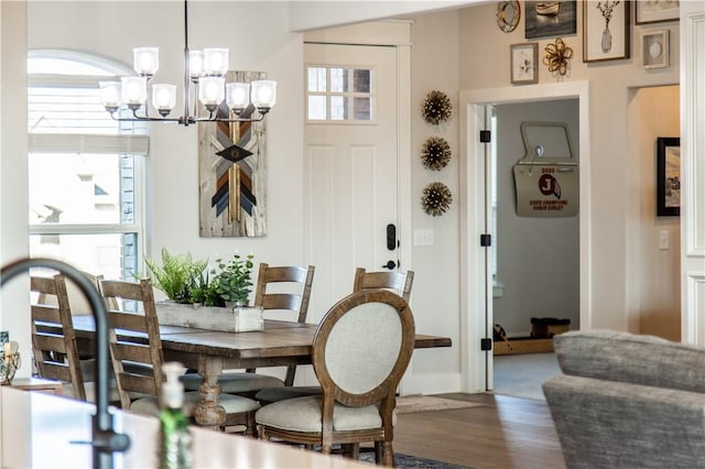 dining space with plenty of natural light, a chandelier, and hardwood / wood-style floors