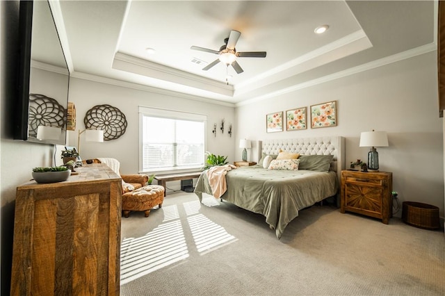 carpeted bedroom featuring crown molding, a raised ceiling, and ceiling fan