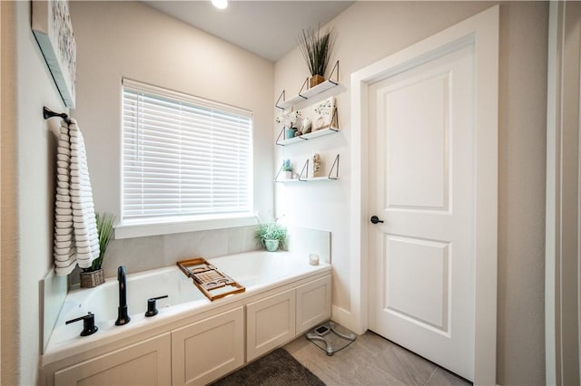 bathroom with a bathing tub and tile patterned floors