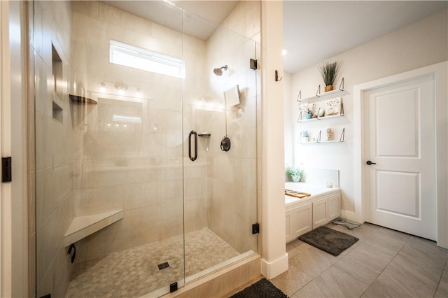 bathroom with tile patterned floors and an enclosed shower