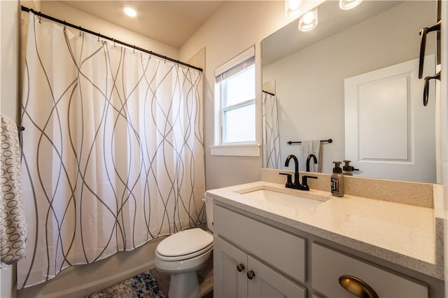 full bathroom featuring vanity, shower / tub combo, and toilet