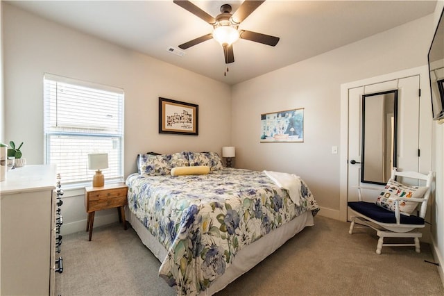 bedroom with ceiling fan and light colored carpet