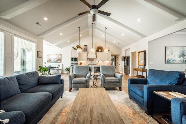 living room with lofted ceiling with beams, ceiling fan, and light hardwood / wood-style floors