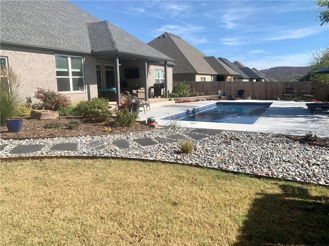 view of swimming pool featuring a yard and a patio