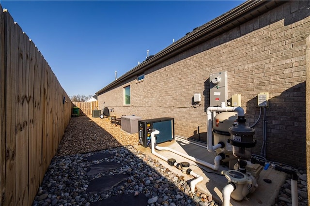 view of property exterior with central AC unit and a patio area