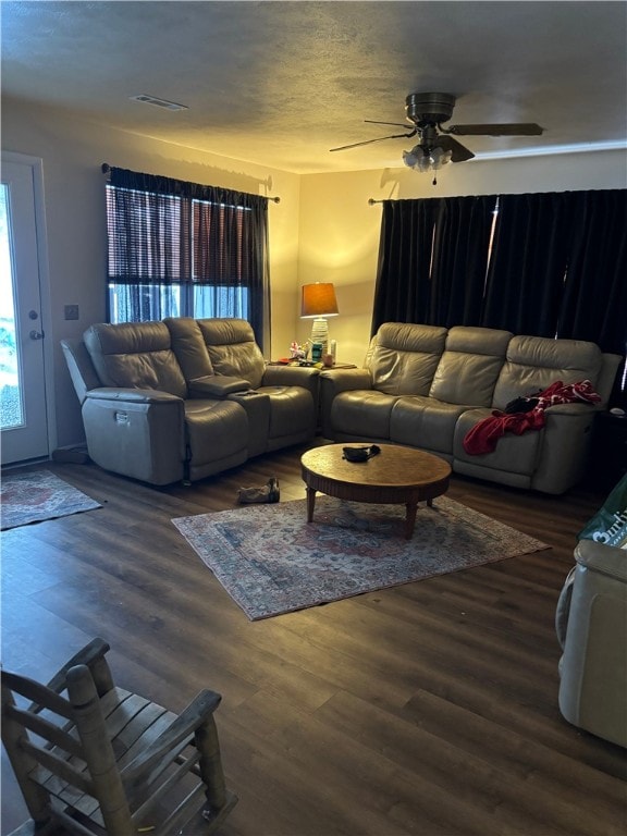 living room with ceiling fan and dark hardwood / wood-style floors