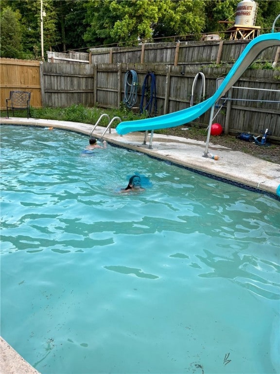 view of swimming pool with a water slide