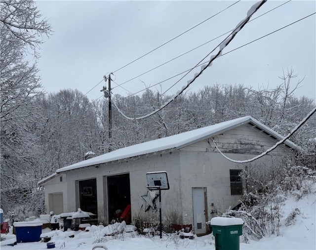 view of snow covered exterior with a garage