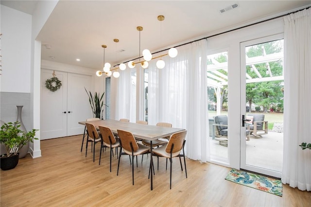 dining space with light hardwood / wood-style floors