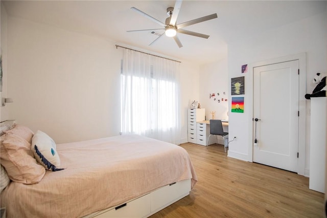 bedroom with ceiling fan and light hardwood / wood-style flooring