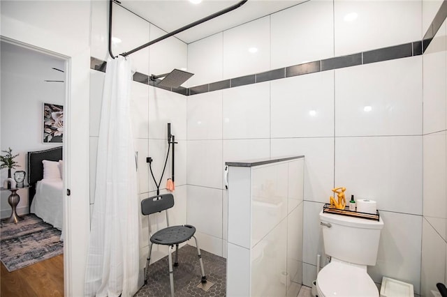 bathroom featuring a shower with curtain, toilet, and hardwood / wood-style flooring