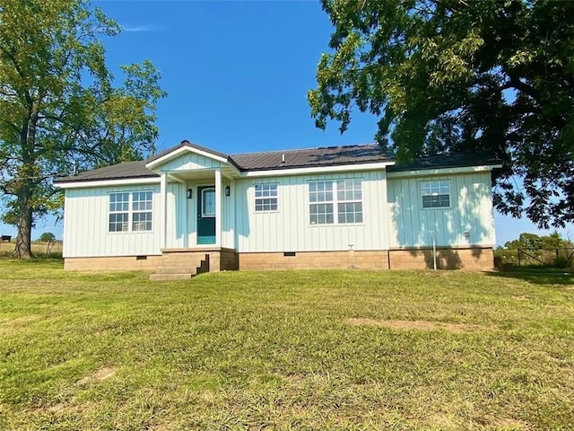 manufactured / mobile home featuring board and batten siding, entry steps, a front lawn, and crawl space