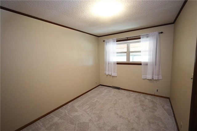 carpeted spare room featuring a textured ceiling