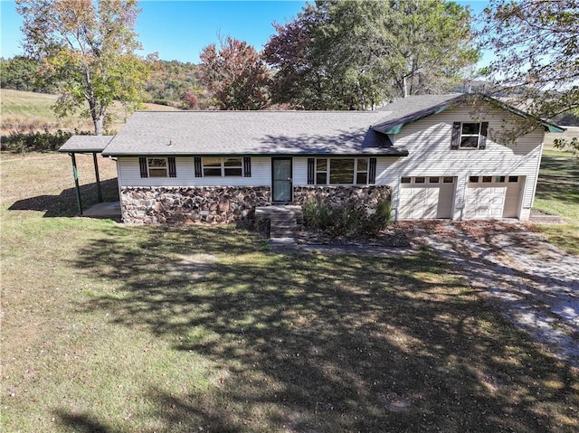 view of front of property with a garage and a front yard