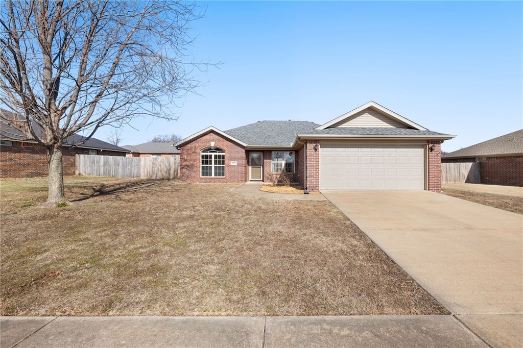 ranch-style house featuring a garage and a front lawn