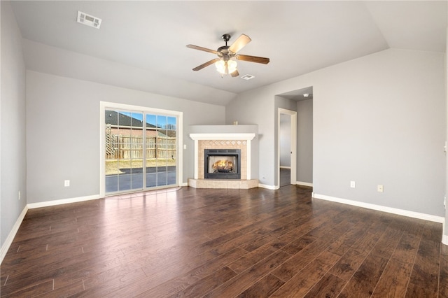 unfurnished living room featuring ceiling fan, lofted ceiling, dark hardwood / wood-style flooring, and a fireplace