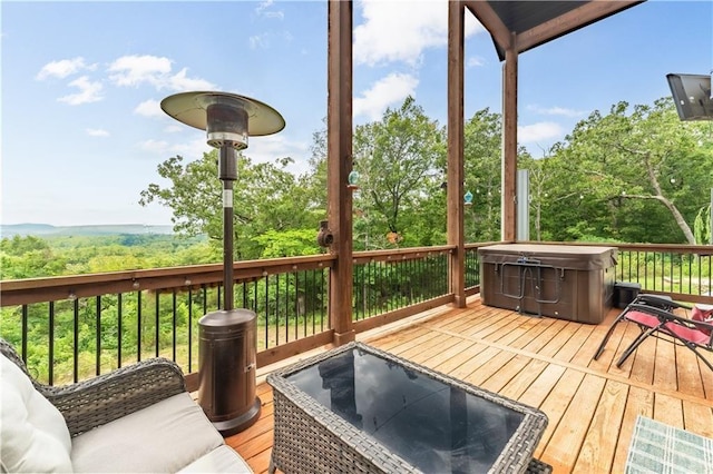 wooden deck with a hot tub