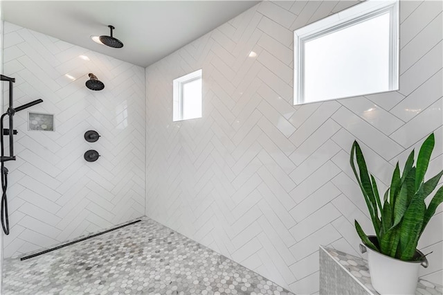 bathroom with tiled shower