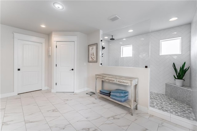 bathroom with a tile shower