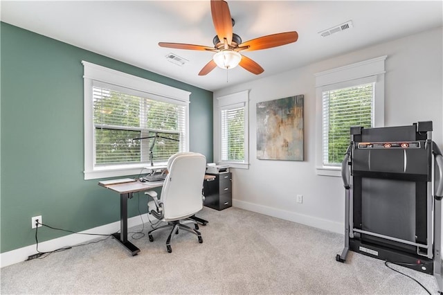 carpeted home office with ceiling fan