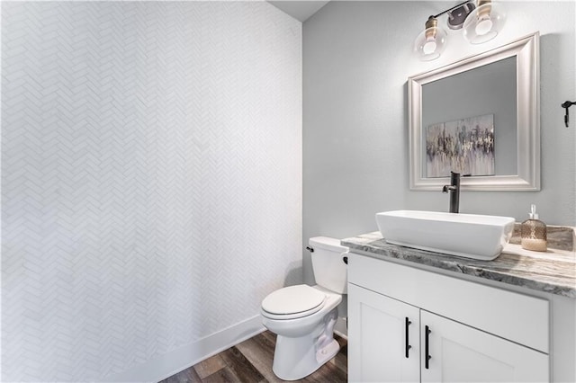 bathroom with vanity, hardwood / wood-style floors, and toilet