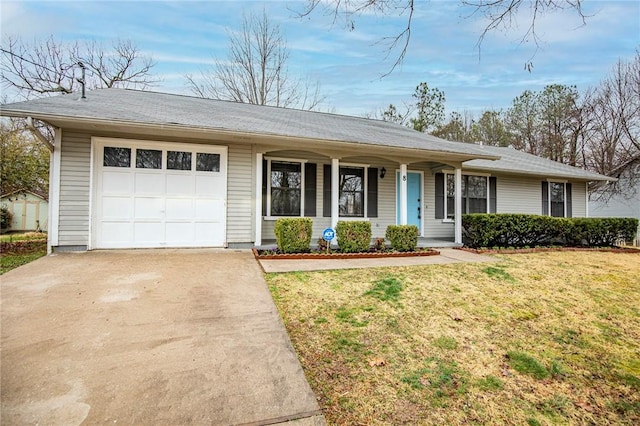 ranch-style house featuring a garage and a front yard