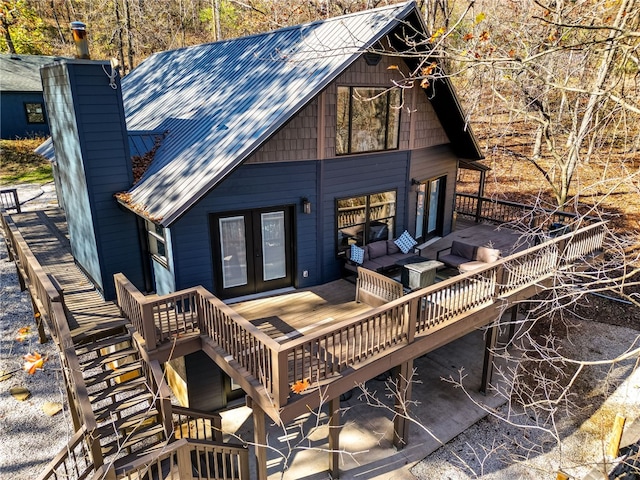 rear view of house with an outdoor living space and french doors