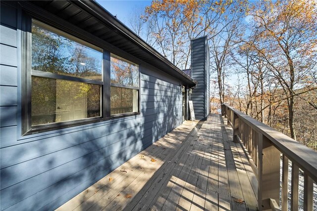 view of property exterior with a wooden deck