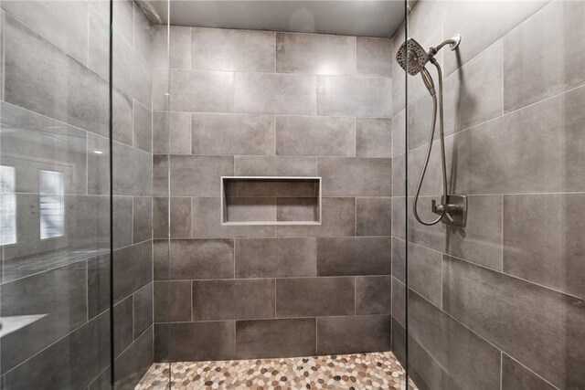 bathroom with tiled shower