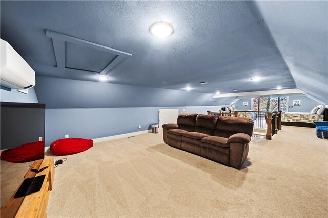 home theater room with vaulted ceiling, a wall mounted air conditioner, light colored carpet, and a textured ceiling