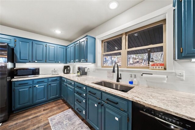 kitchen with blue cabinets, dark hardwood / wood-style flooring, sink, and black appliances